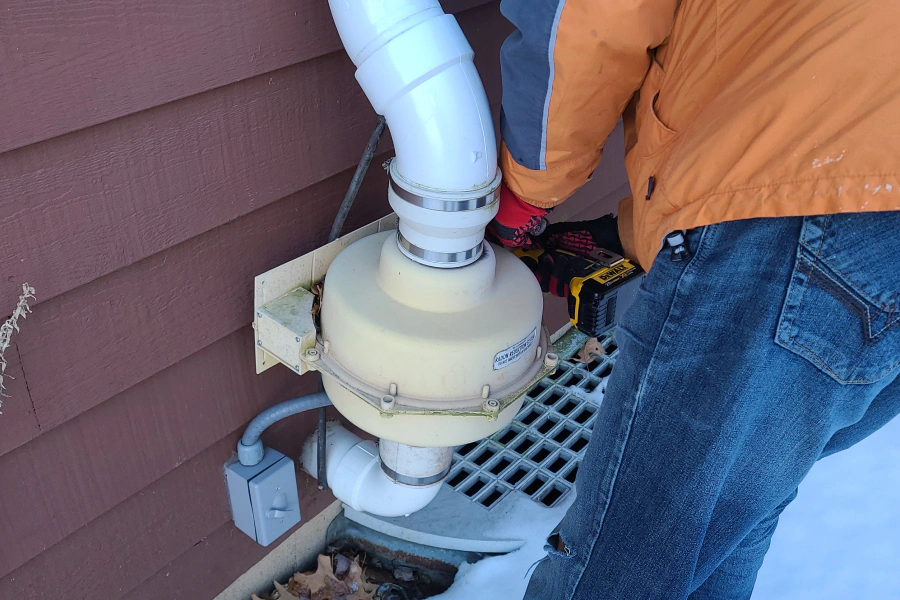 technician giving maintenance to a radon mitigation system plainfield il